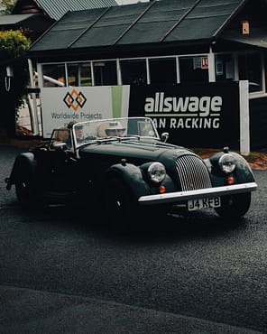menu-15 A vintage Morgan roadster car parked on a street, capturing classic elegance.