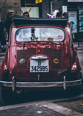 menu-07 Classic vintage car parked on a bustling street in Barcelona, Spain