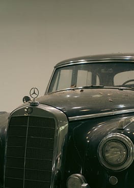 menu-12 Elegant close-up of a vintage Mercedes-Benz showing classic design.